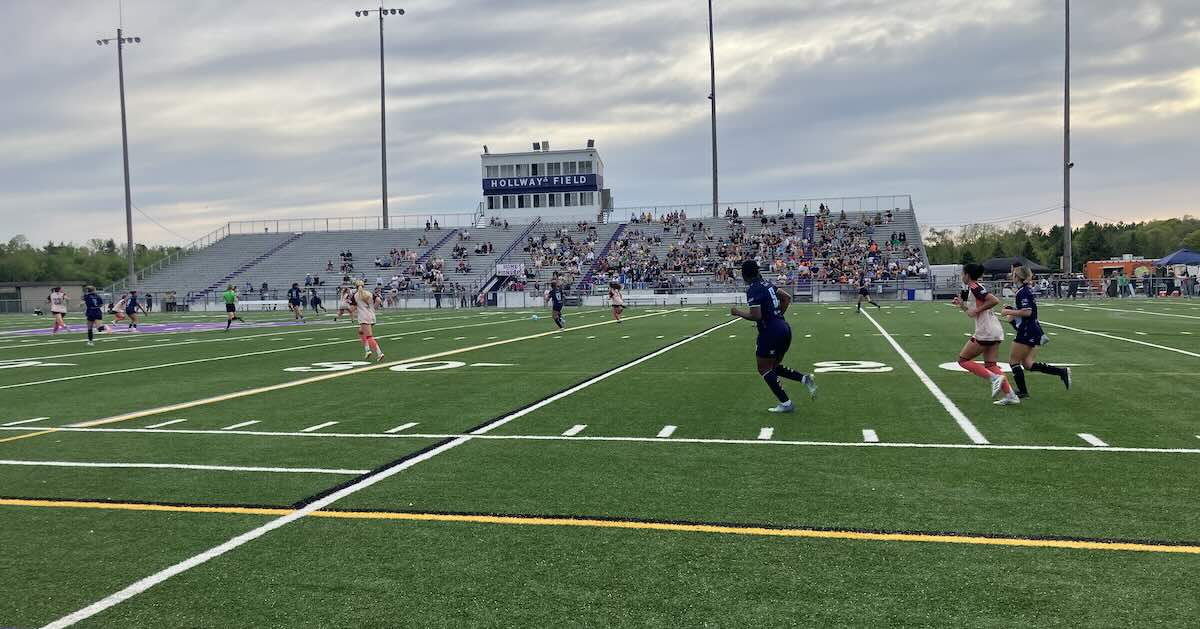 AFC Ann Arbor - AFC women's team in blue looking back at home team sideline