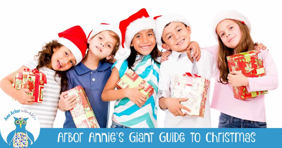 Arbor Annie's Giant Guide to Christmas in Ann Arbor - kids holding presents & in santa hats plus Ann Arbor with Kids logo