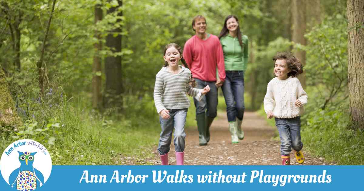 Ann Arbor Walks without Playgrounds - a family walking through a park - 2 kids run ahead of parents
