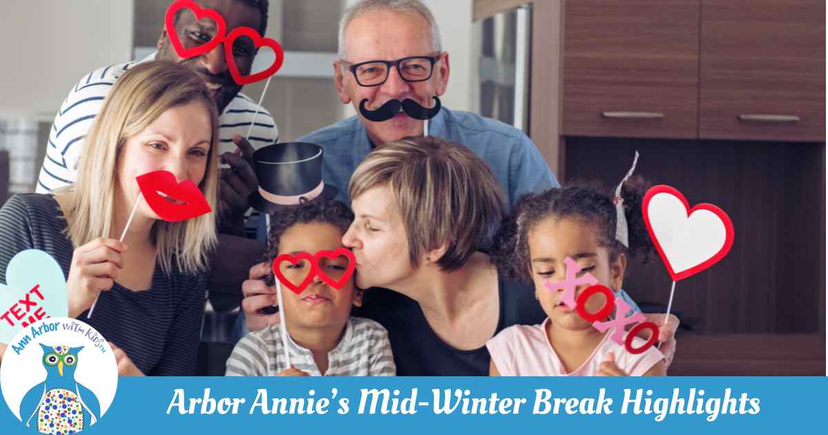 Arbor Annie's Mid-Winter Break Highlights - mom, dad, grandparents & kids pose with Valenine's prop signs- hearts, XO, Text Me Candy Heart. lips, heart glasses & mustache