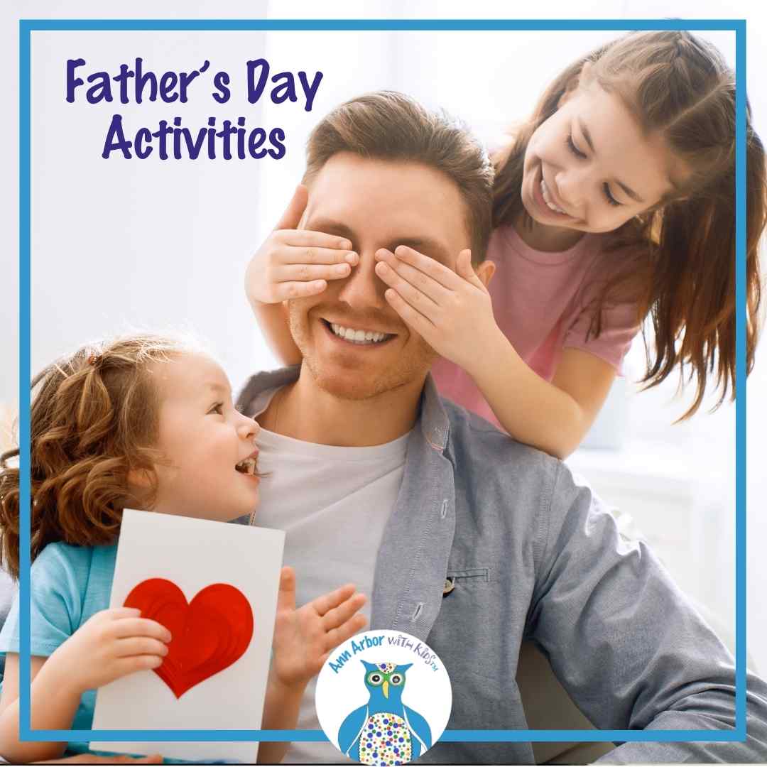 Father's Day Activities - a preschool girl covers dad's eyes while a toddler daughter sits in his lap holding a card with a big red heart