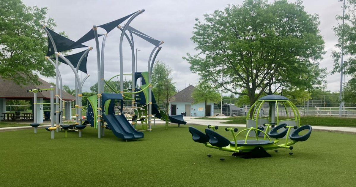 Bicentennial Park - new playground with large see-saw and play structure with pavillion and bathroom building behind it