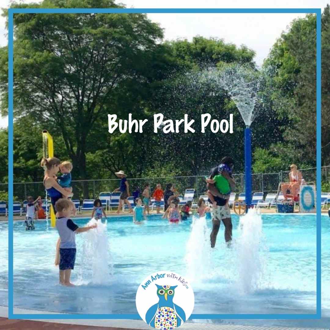 Buhr Park Pool - tot pool with parents & tots enjoying the fountains and overhead sprayers
