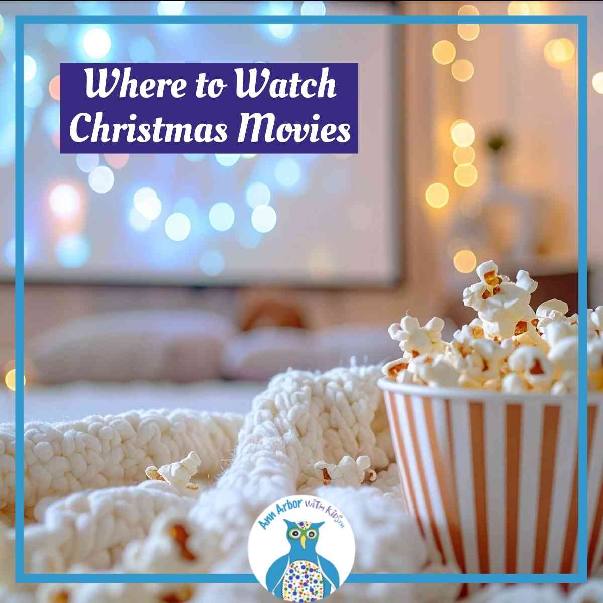 Where to Watch Christmas Movies - popcorn in bowl on white blanket with screen that has colored lights on plus white lights next to screen