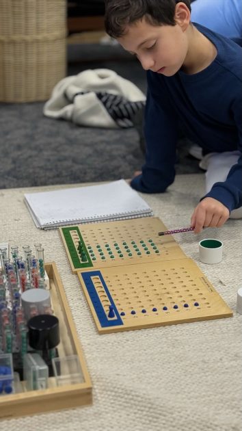 Daycroft School - a young student works with counting trays with blue and green colored balls