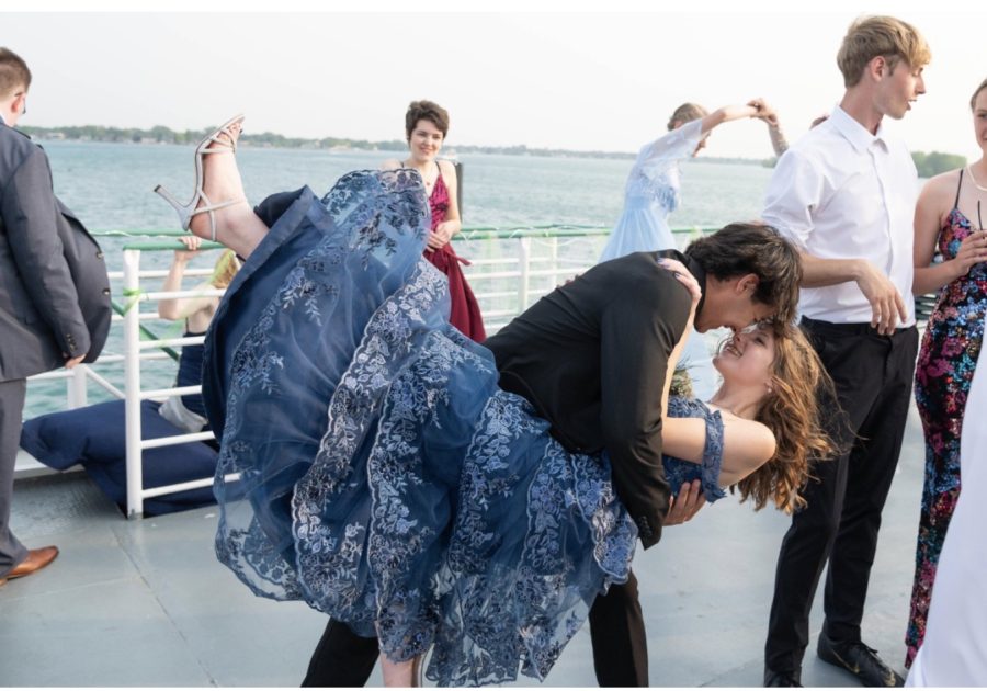 Students dressed for prom dancing and socializing on the river boat