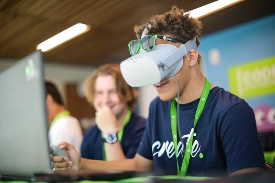 iD Tech Camp - teen students work at laptop wearing virtual reality glasses