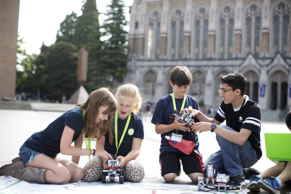 iD Tech Camps - students work with robots outside on a college campus