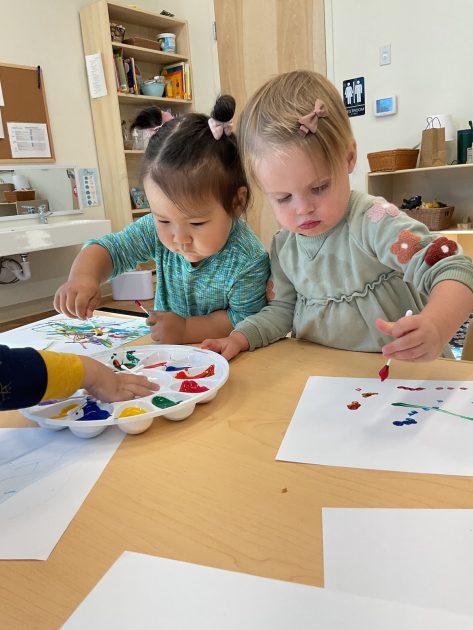 Ivybrook Academy - toddlers painting using a Qtip and a palette