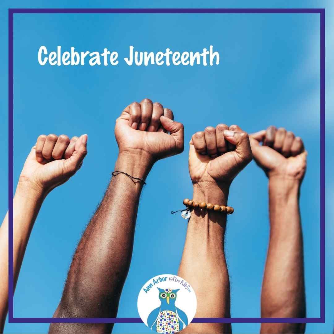 Celebrate Juneteenth - fists raised in the air in front of blue sky