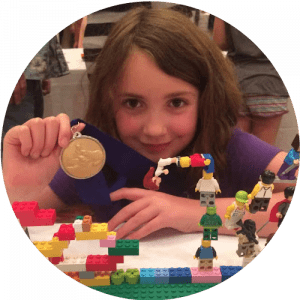 LEGO Contest  - Girl holding medal with LEGO creation representing 10