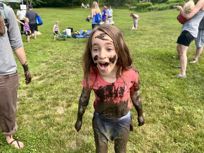 Mud Day - Girl covered in mud laughs