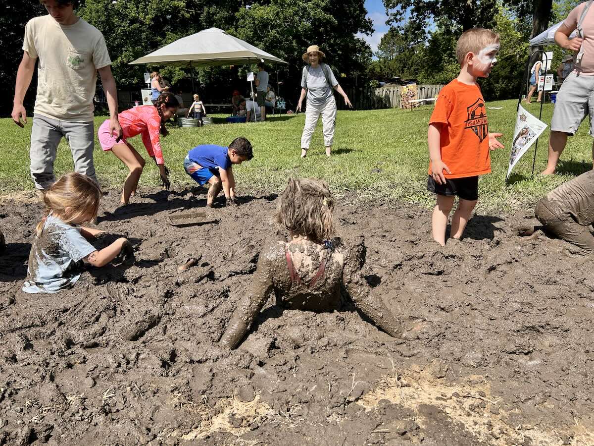 Mud Day - Kids play in a big mud pit