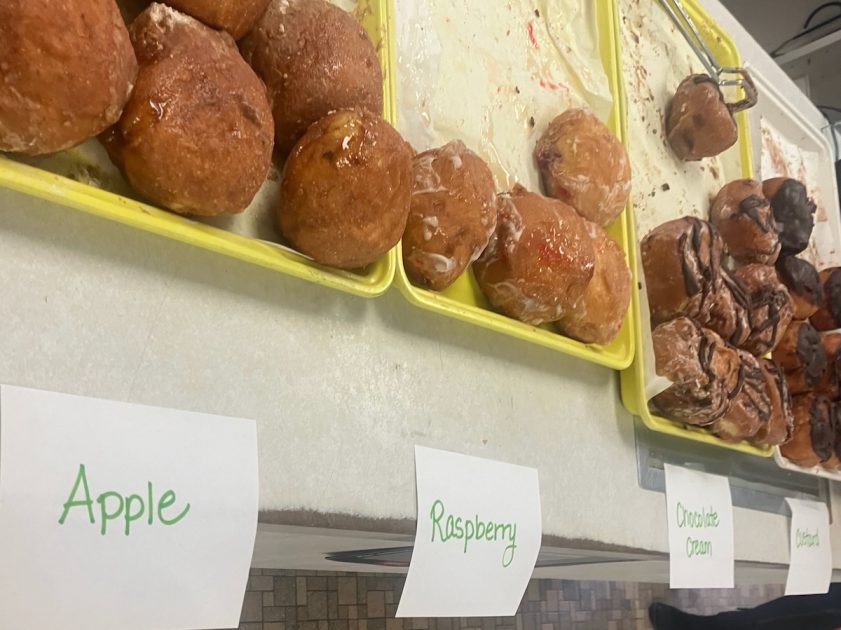Trays of Paczki labeled Apple, Raspberry, Chocolate Cream and Custard on the counter at Washtenaw Dairy