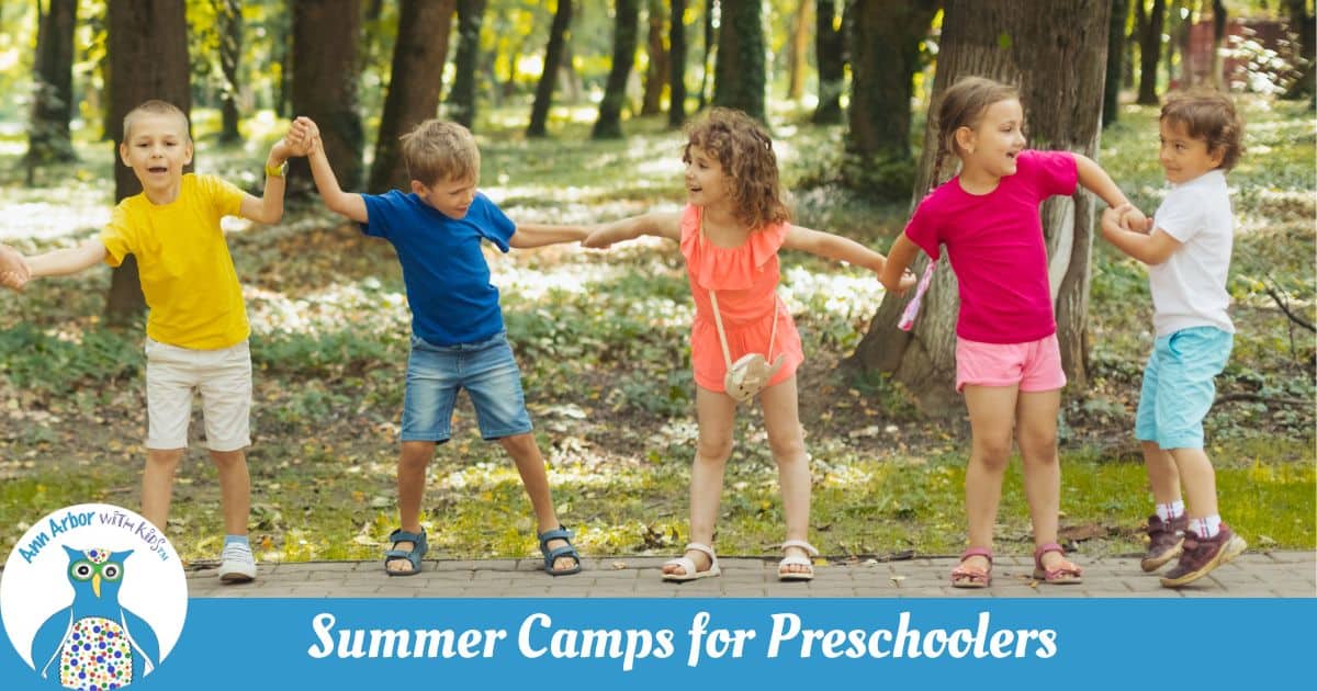 Ann Arbor Summer Camps for Preschoolers - Preschoolers holding hands while playing outside in the woods