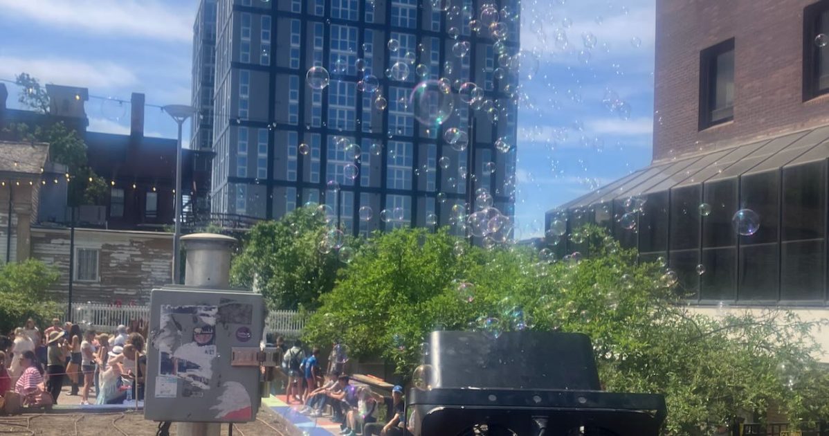 Sonic Lunch - bubbles from bubble maker rise over Liberty Plaza