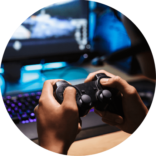 Video Games - photo of video game on monitor with keyboard visible while user holds video game controller.