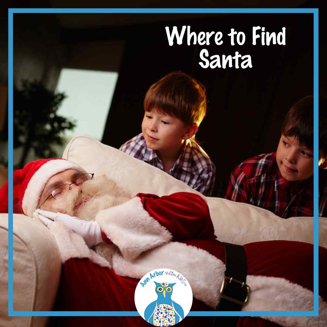 Where to Find Santa - Santa sleeping on sofa in front of tree as two boys peek over him.