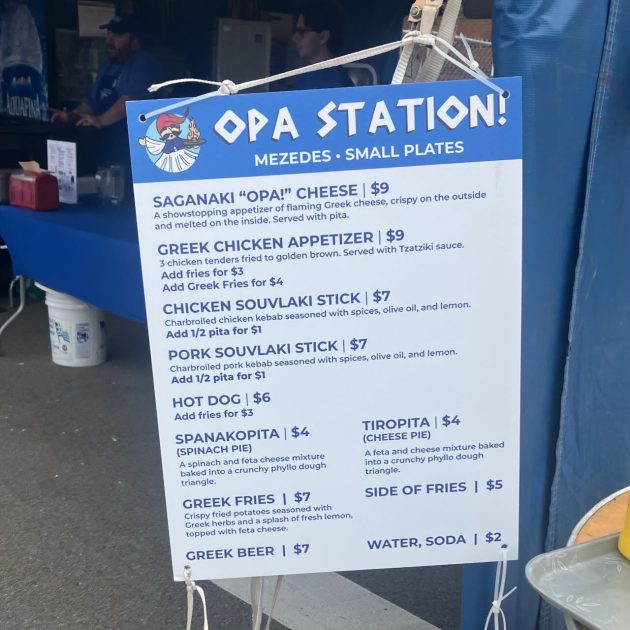 Ya'ssoo Greek Festival Mezedes menu - Opa Station - Mezedes Small Plates
Saganaki "Opa!"  Cheese - $9
Greek Chicken Appetizer $9
Chicikeen Souvlaki Stick - $7
Pork Souvlaki Stick - $7
Hot Dog $6
Add Fries $3
Spanakopita $4
Tiropita - $4
Greek Fries $7
Side of Fries $5
Greek Beer - $7
Water, Soda $2