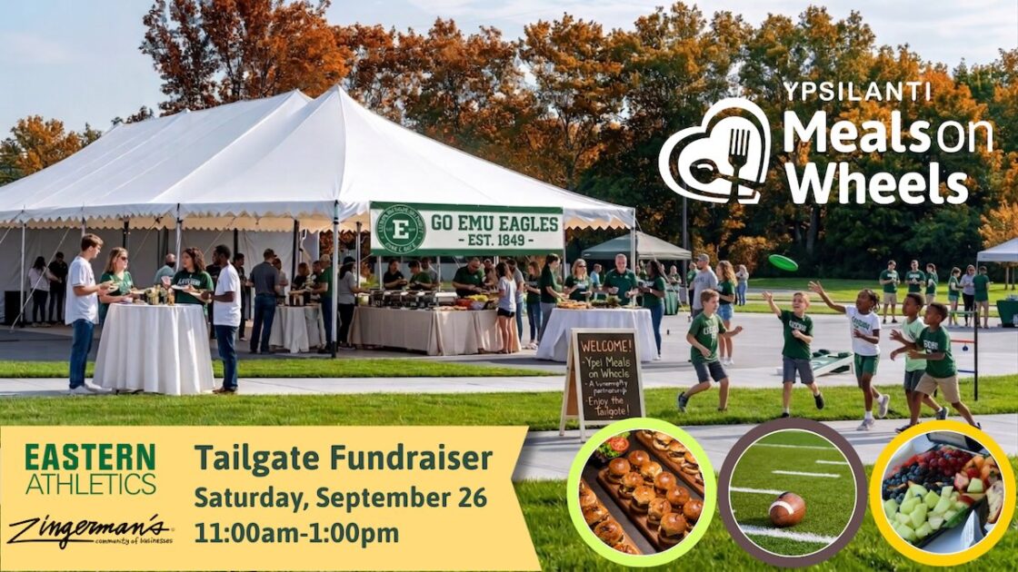 Ypsilanti Meals on Wheels - Tailgate Fundraiser Saturday, September 26 11:00am-1:00pm Eastern Athletics & Zingerman's Community of Businesses - a tent set up for tailgating - banner says Go EMU Eagles Est 1849. Sign says welcome Ypsi Meals on Wheels. Guests wearing EMU gear get food under tent at buffet, gather at tables eating/talking and kids throwing a frisbee